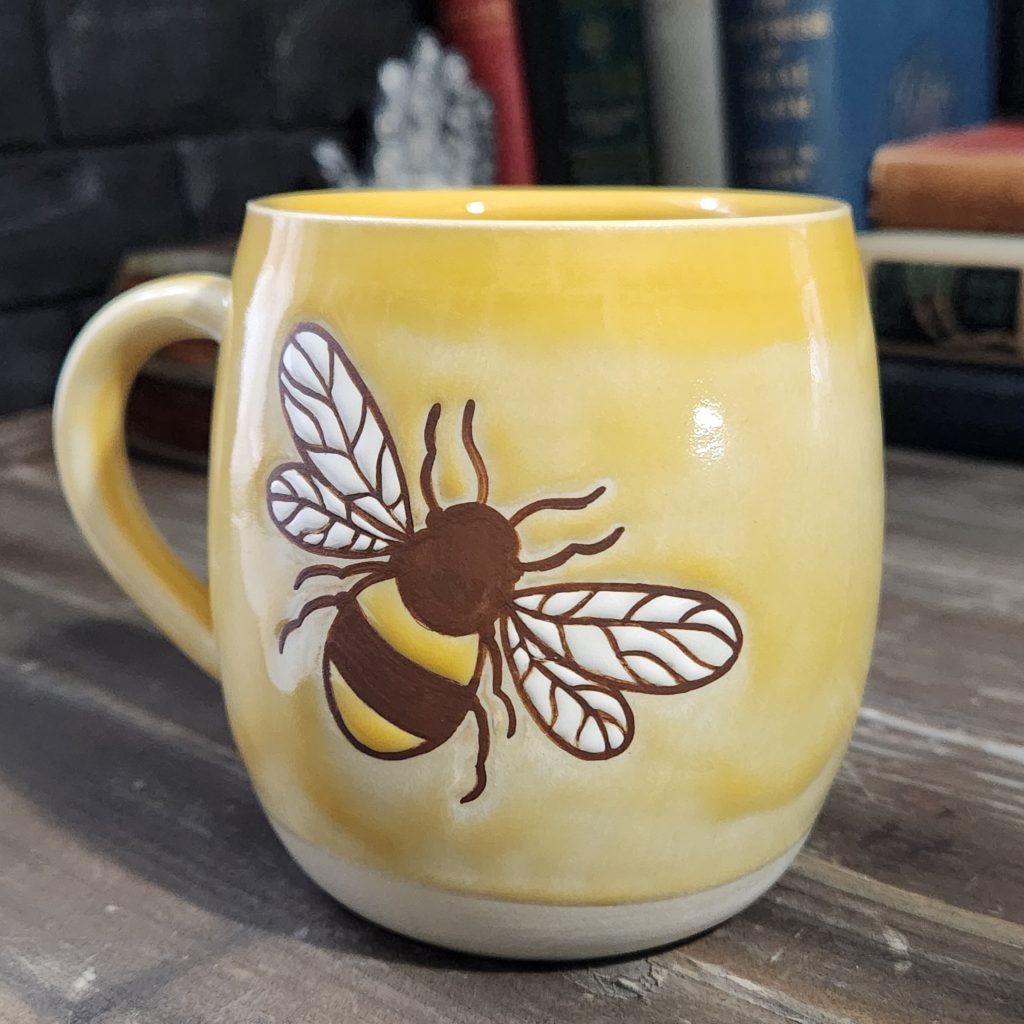 Bee motice on a oozy yellow mug